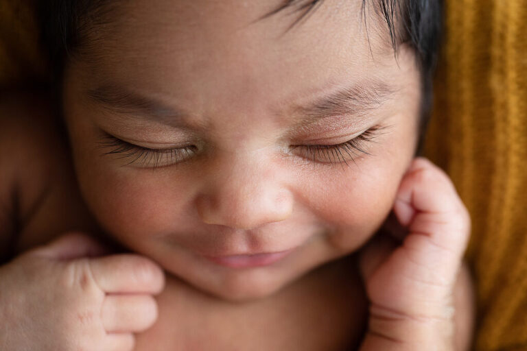 photography of Darwin newborn baby eyelashes smiling 