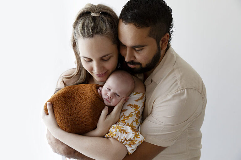 parents holding newborn baby darwin photograph