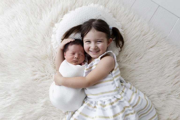 photography darwin newborn baby with sister white rug