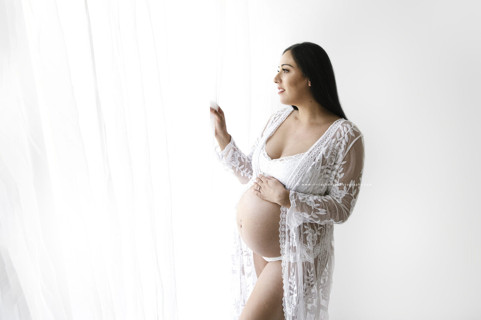 Maternity photographer take in darwin with Lace dress curtain